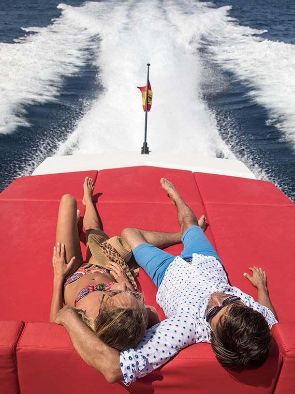 Couple aboard a Vanquish Yacht sailing in the waters of Ibiza and Formentera